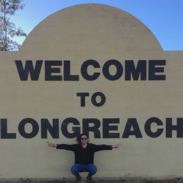 JCU Physio student, Mason in front of the Welcome to Longreach sign